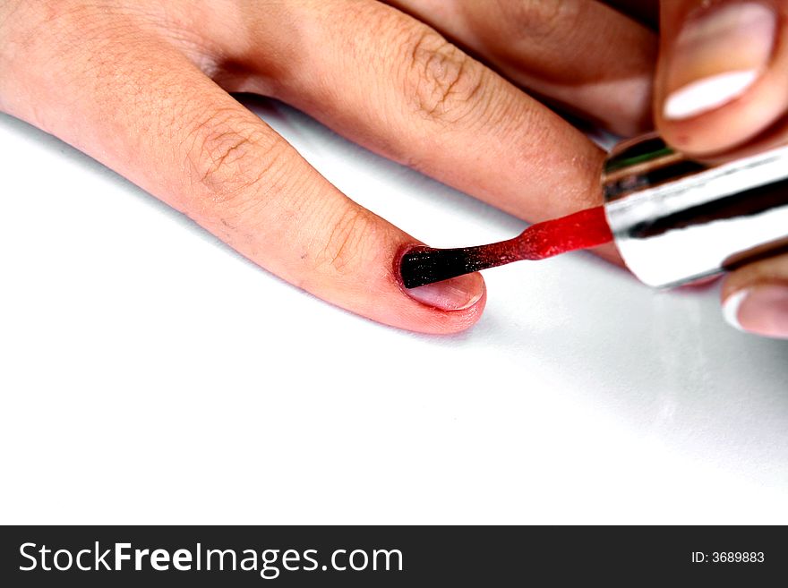 Doing french manicure with red nail polish. Doing french manicure with red nail polish