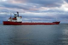 Cargo Vessel Going To The Open Sea Stock Photo