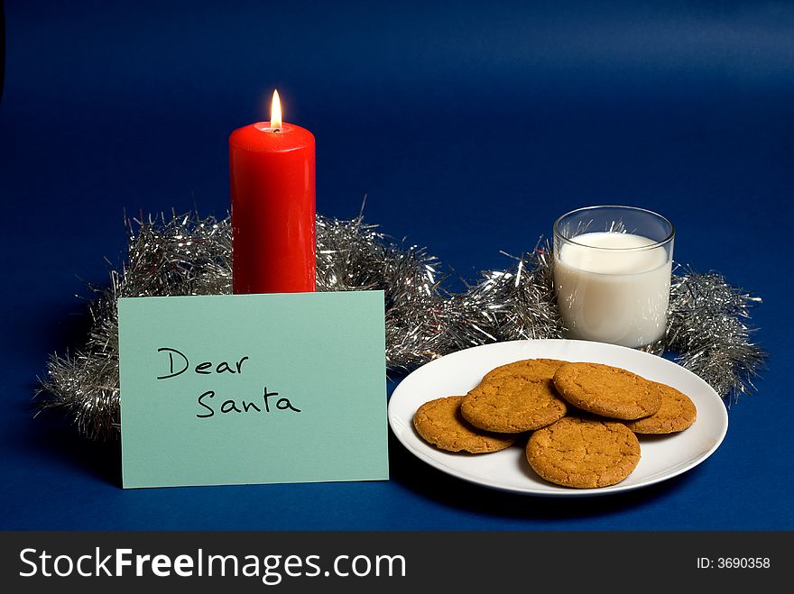 Dear Santa note left beside a glass of milk and biscuits for Santa. Dear Santa note left beside a glass of milk and biscuits for Santa