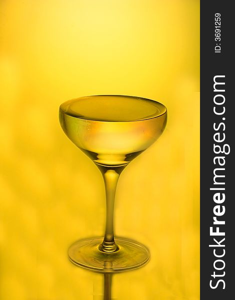 Glass for a champagne on a yellow background. Glass for a champagne on a yellow background