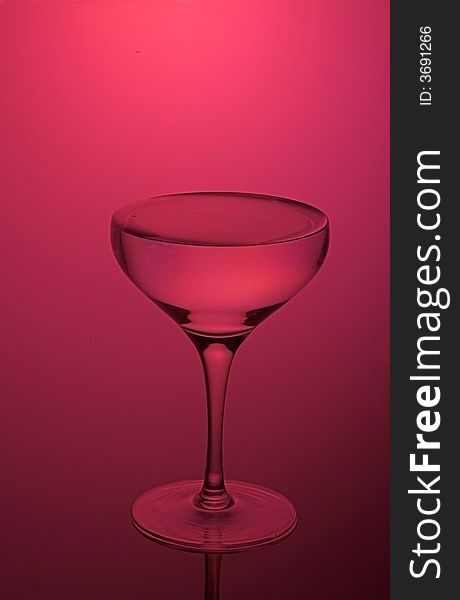 Glass for a champagne on darkly red background. Glass for a champagne on darkly red background