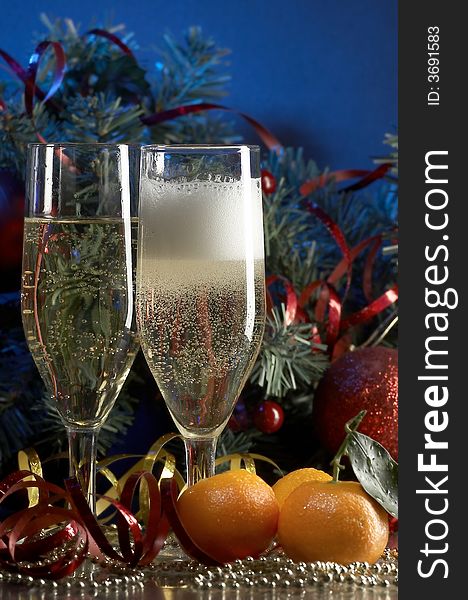 Still life with glass with champagne on the blue background