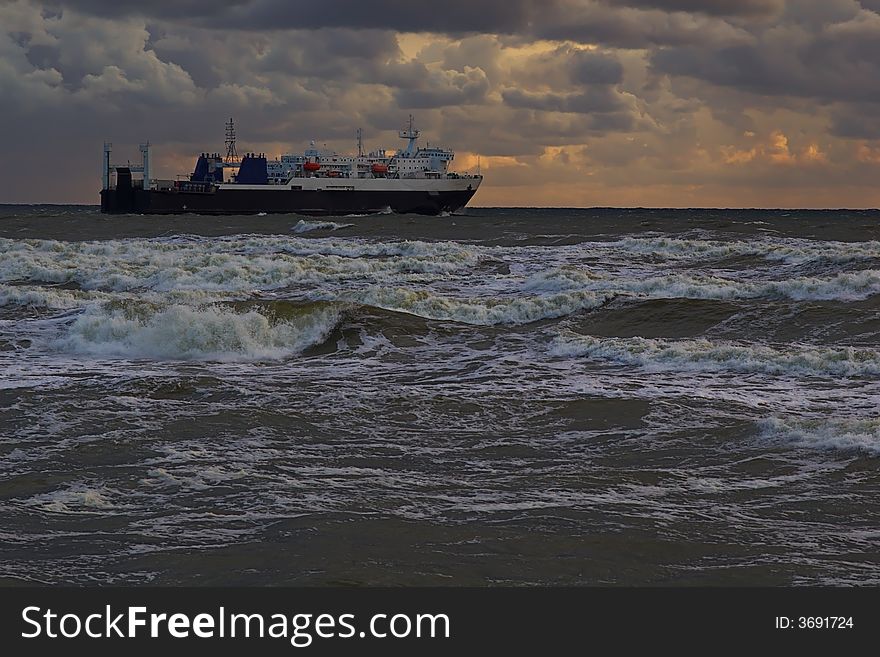 Ferry vessel heading forward to the stormy sea