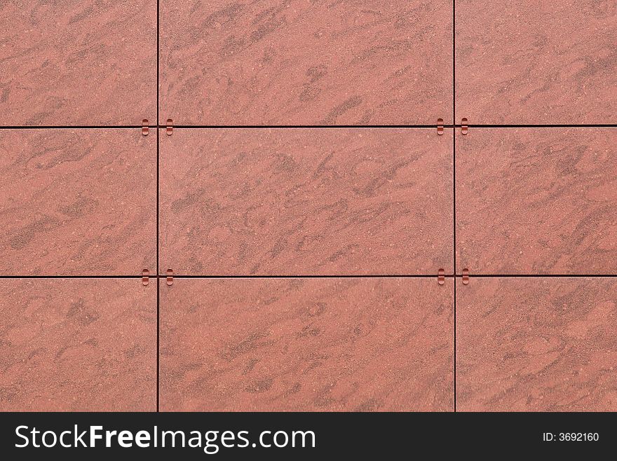 Panelled  brown stone-like background with visible seams. Panelled  brown stone-like background with visible seams