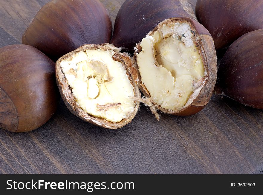 Chestnuts cut in background of wood
