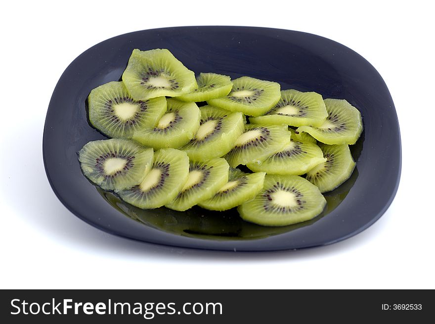 Slices of kiwi cut in black plate