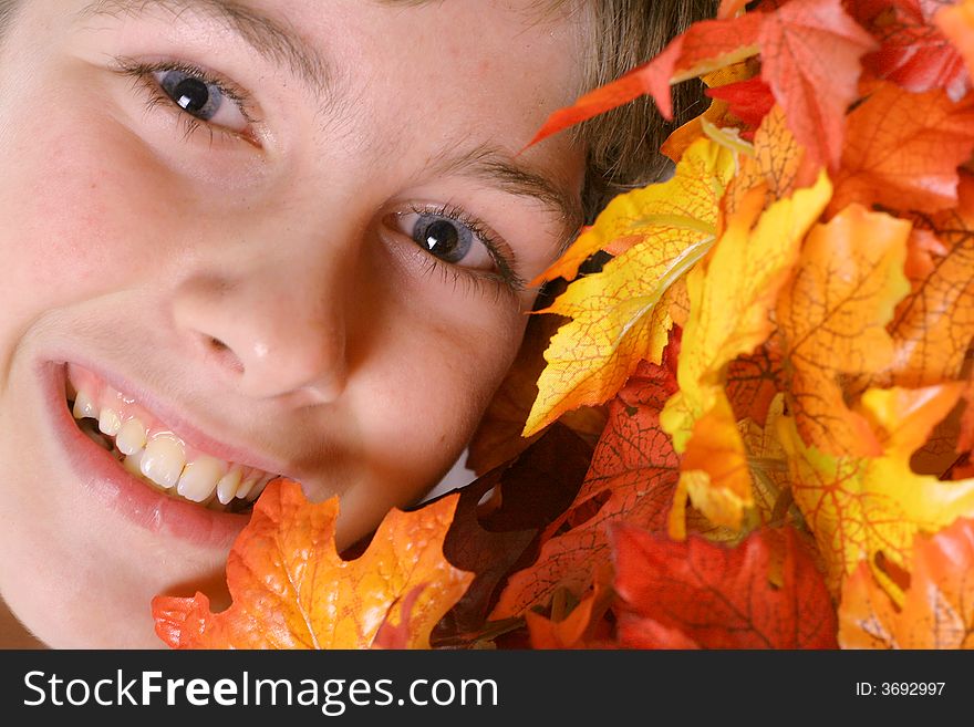 Shot of a young boy headshot in autumn leaves