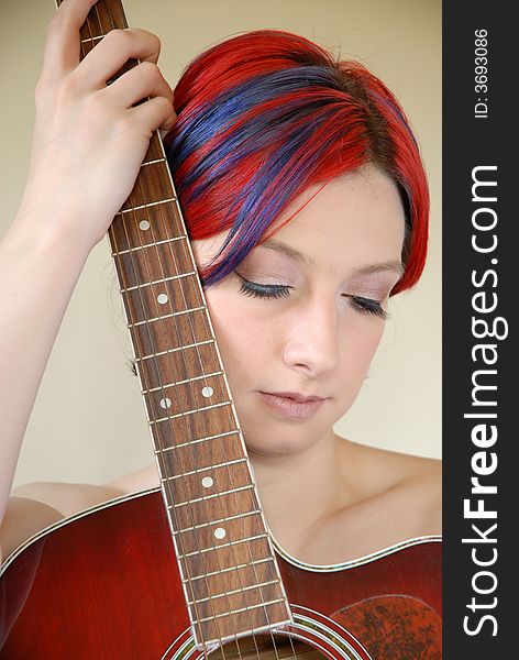 Alternative model with red hair holds guitar. Alternative model with red hair holds guitar.