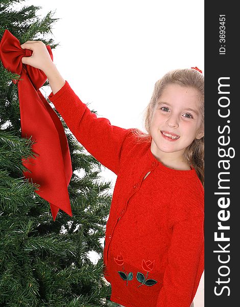 Young child hanging bow on tree smile