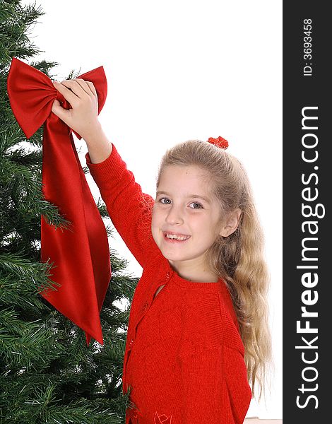 Young Child Hanging Bow On Tree