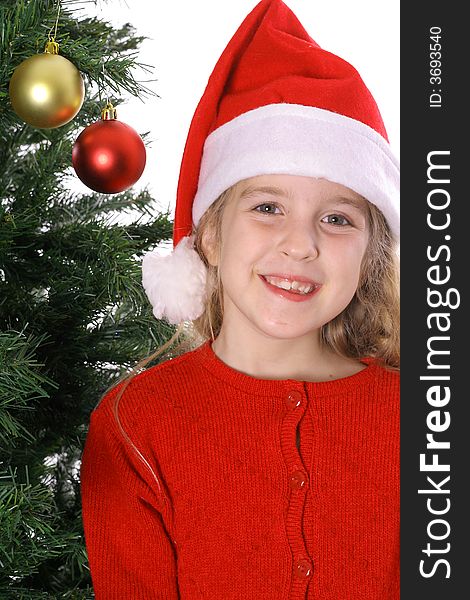 Photo of a Santa child by Christmas tree vertical