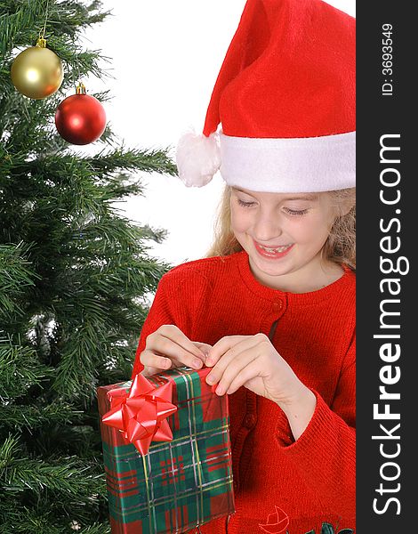 Child with present by christmas tree