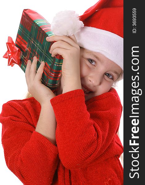 Photo of a Little girl shakin a present vertical