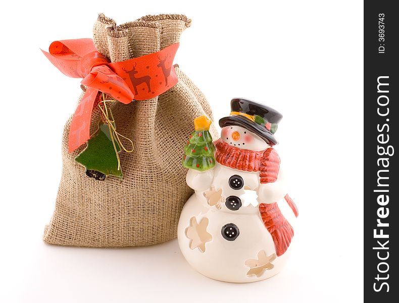 Snowman on white, porcelain with jute bag, gift, present. Snowman on white, porcelain with jute bag, gift, present