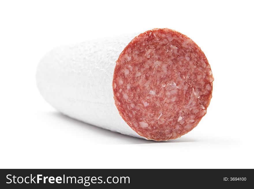 Piece of salami. White background.