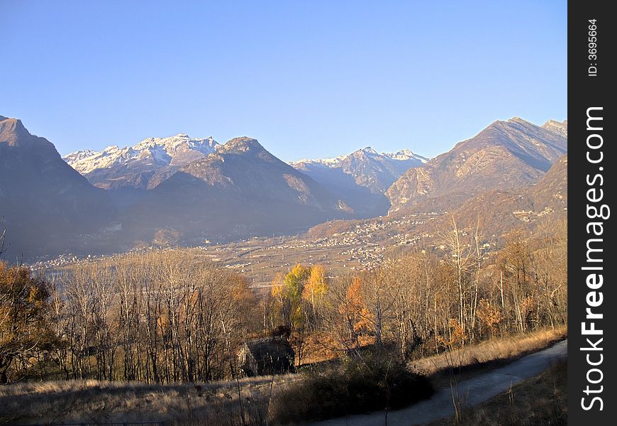 A panorama of Ossola Valley. Mountains in fall season with the first snow, Italy, HDR. A panorama of Ossola Valley. Mountains in fall season with the first snow, Italy, HDR