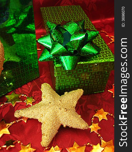 Green gift box and golden star on celebration background