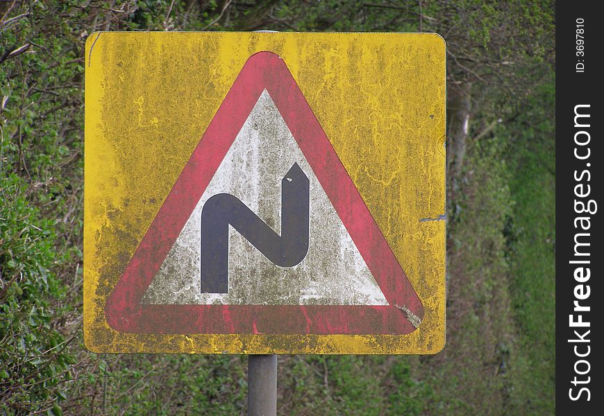 Muddy double-bend sign in the Wiltshire countryside, England. Muddy double-bend sign in the Wiltshire countryside, England.