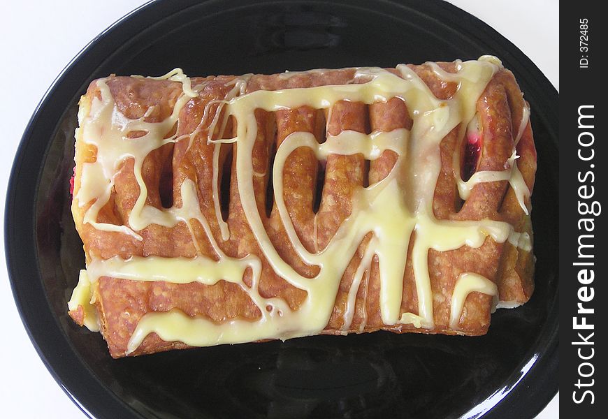 Cherry danish on a black plate