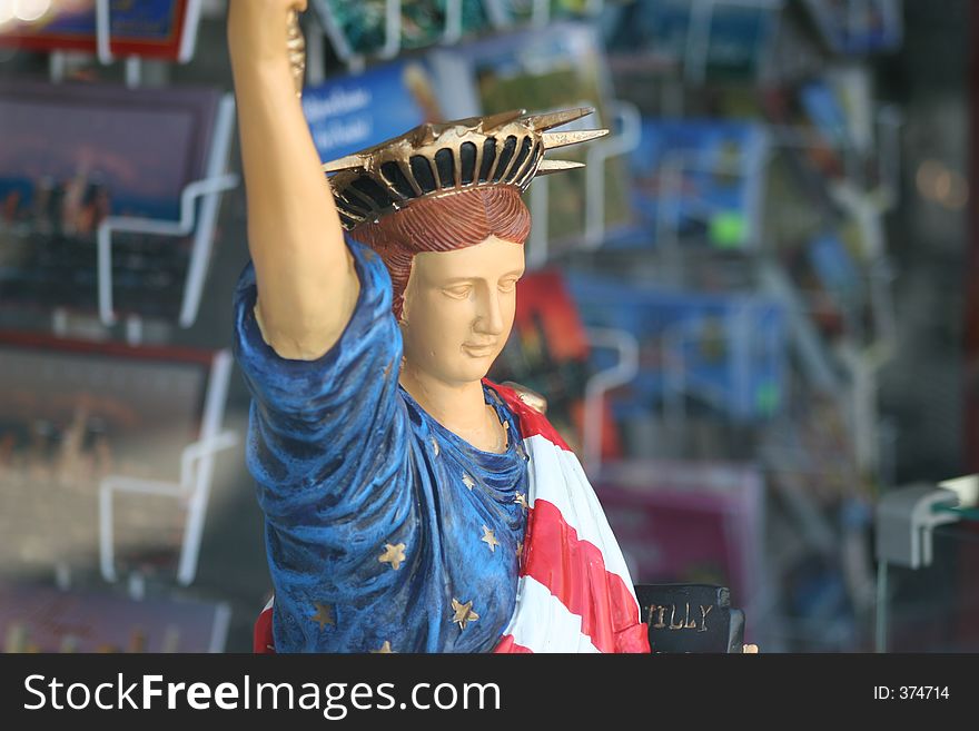 Small statue of liberty draped in american flag. Small statue of liberty draped in american flag