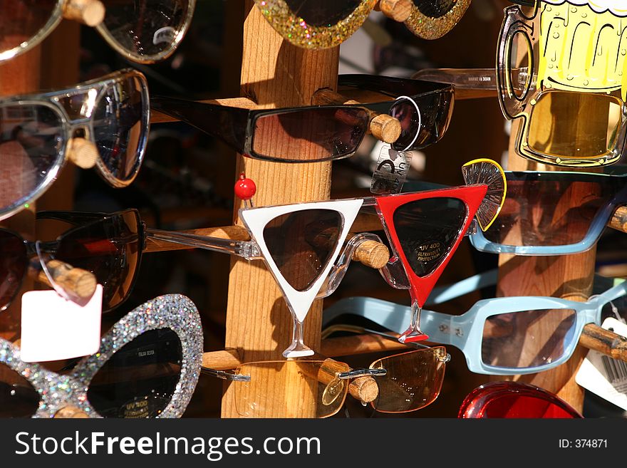 A variety of sunglasses on display for sale. A variety of sunglasses on display for sale