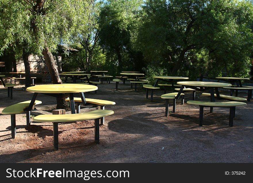 Abandoned picnic area with yellow tables. Abandoned picnic area with yellow tables