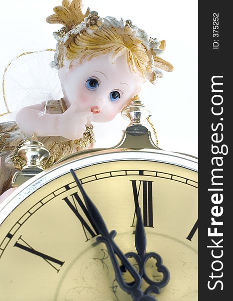 Little angel figurine with clock close-up. Little angel figurine with clock close-up