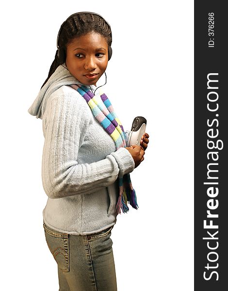 A pretty teenage girl listening to a portable cd player. With clipping path. A pretty teenage girl listening to a portable cd player. With clipping path.