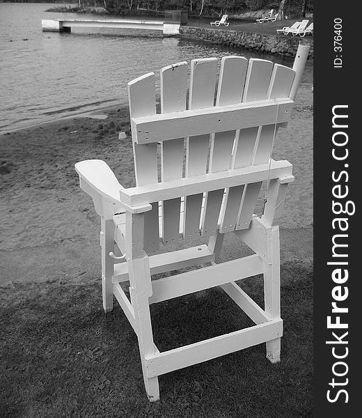 Empty Lifeguard Chair in Black and White on a pond