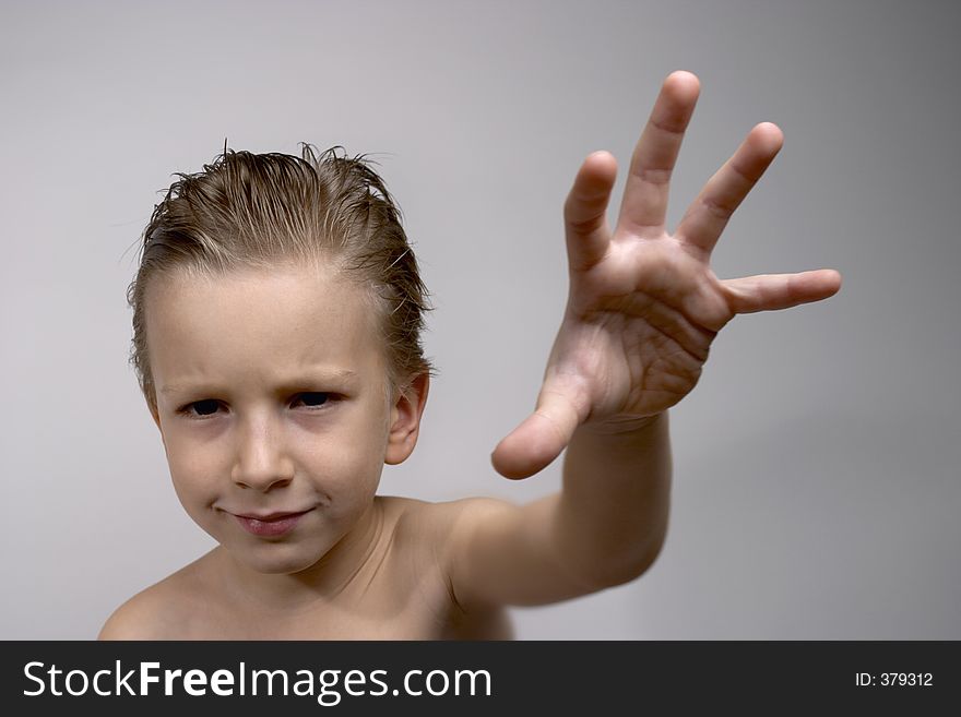 Kid posing with serious look. Focus on face.