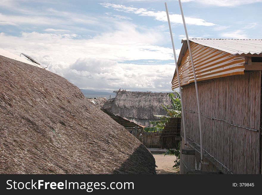 Village scene with solar panel on thatched roof 1038. Village scene with solar panel on thatched roof 1038