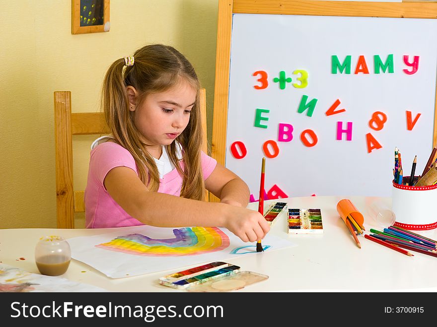 Pretty schoolgirl has drawn a rainbow