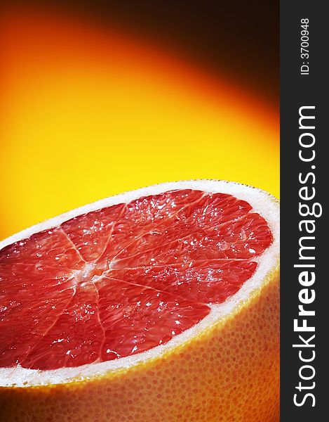 Half of grapefruit on a orange background