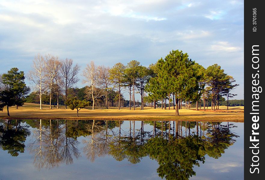A golfers dream: A calm wind-free day on the golf course. A golfers dream: A calm wind-free day on the golf course.