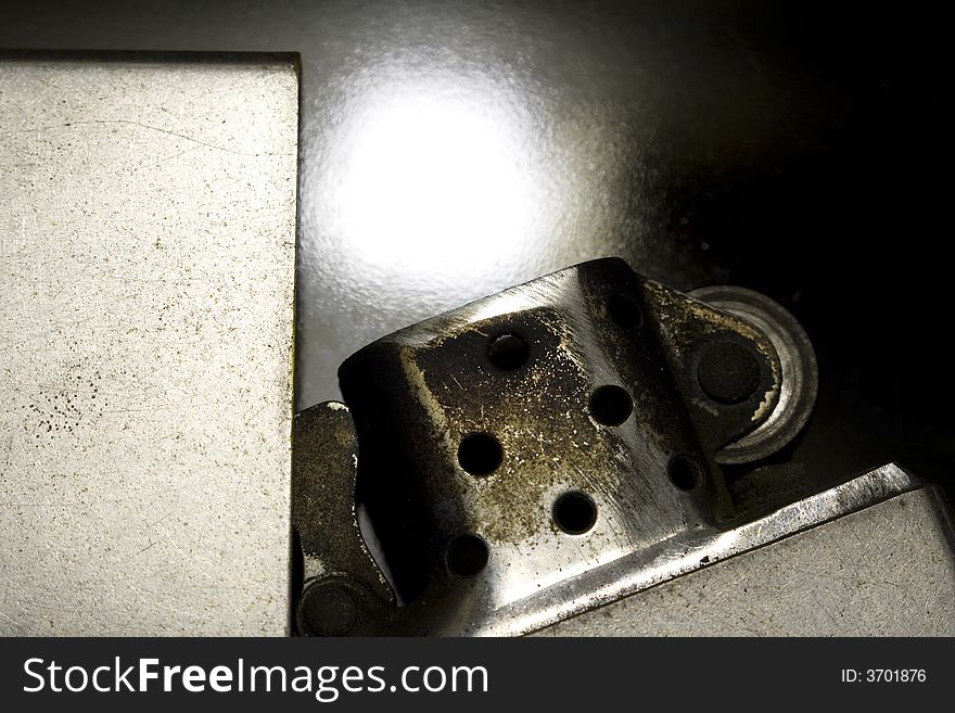 Macro close-up of old silver lighter with black background. Macro close-up of old silver lighter with black background