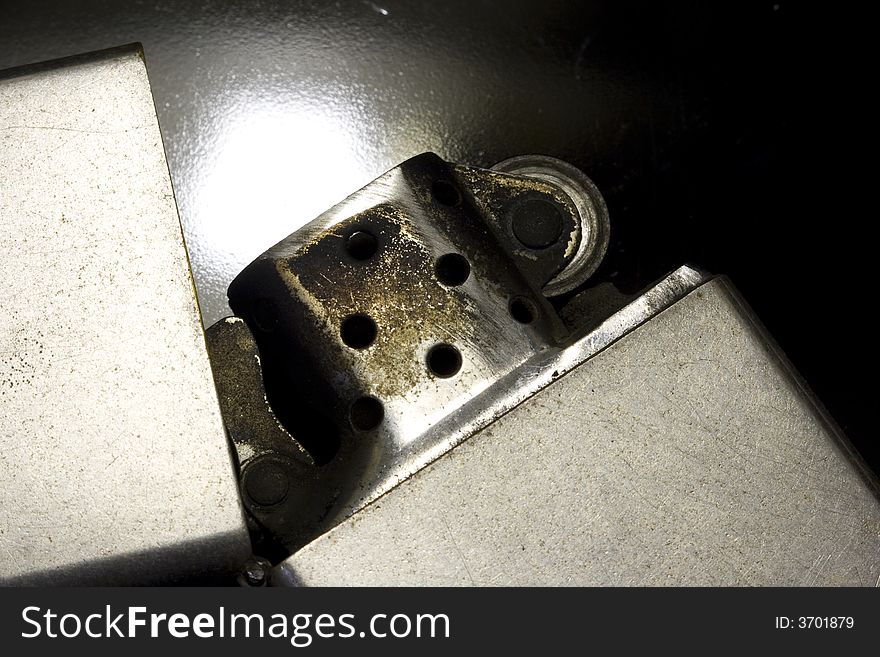 Macro close-up of old silver lighter with black background. Macro close-up of old silver lighter with black background