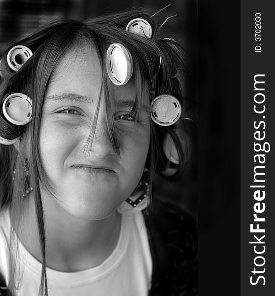 Portrait of teenage girl with curlers in her hair. Portrait of teenage girl with curlers in her hair