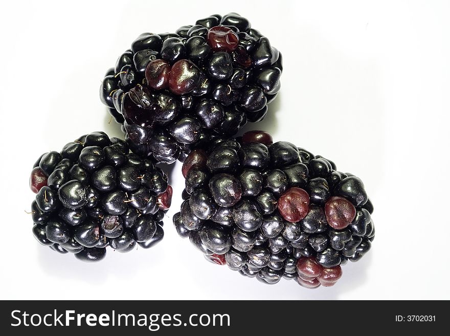 Macro close-up of three berries of blackberry isolated with white background. Macro close-up of three berries of blackberry isolated with white background