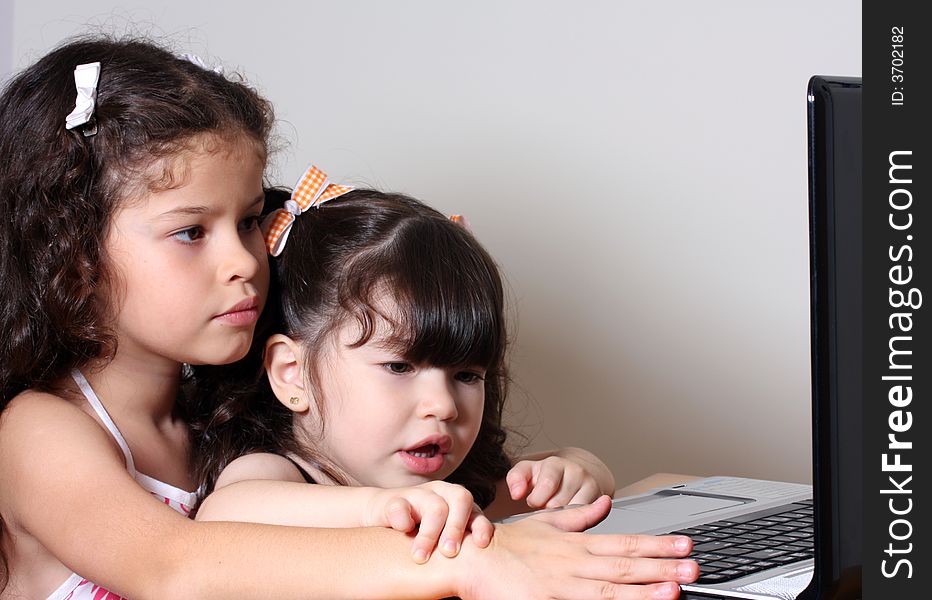 Two little girl work in the computer. Two little girl work in the computer