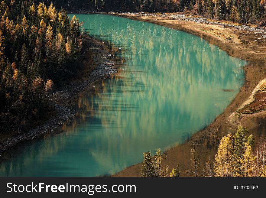 Kanas is Mongolian for The Lake in the Canyon. Here, in this picture, is the river leaving the Kanas lake. The winding river passes through some wonderful scenic lookouts. Moon Bay is one of them. The color of its water looks like jade and the currents here become slowly here. Trees on the riverside mountain are reflected by surface in the moon-like bay. Kanas is Mongolian for The Lake in the Canyon. Here, in this picture, is the river leaving the Kanas lake. The winding river passes through some wonderful scenic lookouts. Moon Bay is one of them. The color of its water looks like jade and the currents here become slowly here. Trees on the riverside mountain are reflected by surface in the moon-like bay.