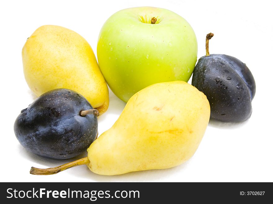 Close-up of fresh yellow pears, green apple and plums. Close-up of fresh yellow pears, green apple and plums