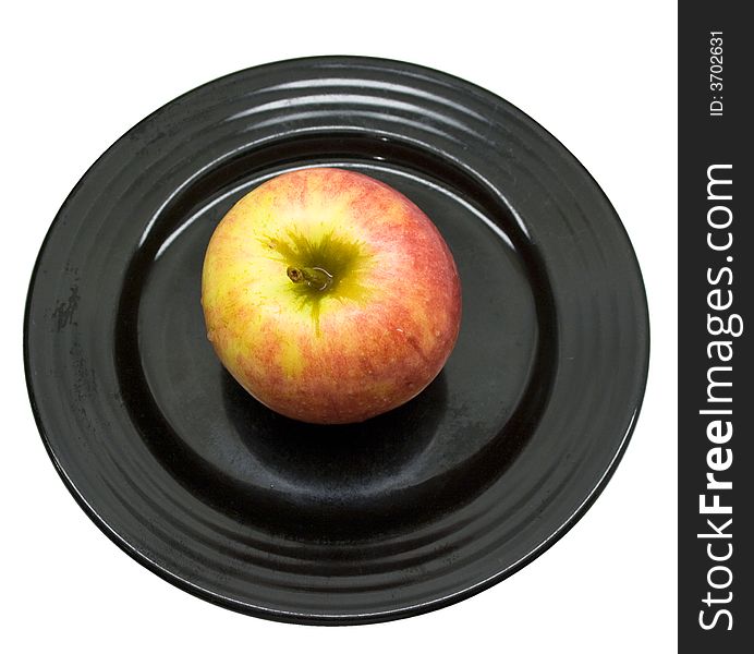 Close-up of fresh apple on a black plate