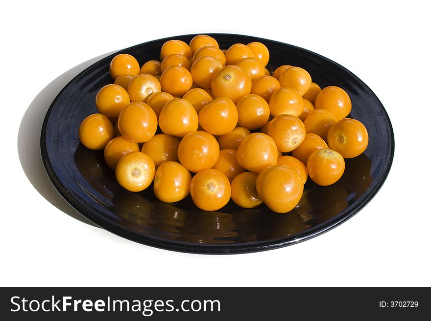 Close-up of black plate with cape gooseberries. Close-up of black plate with cape gooseberries