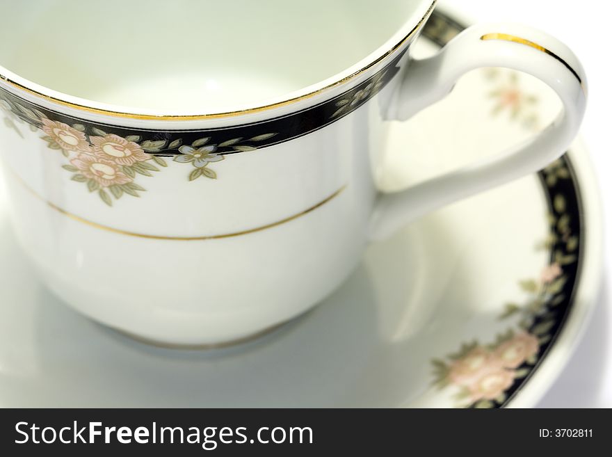 Macro close-up of porcelain tea cup and saucer with white background. Macro close-up of porcelain tea cup and saucer with white background