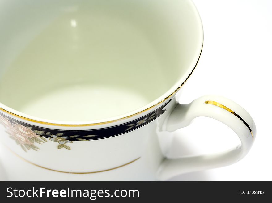 Macro close-up of porcelain tea cup with white background