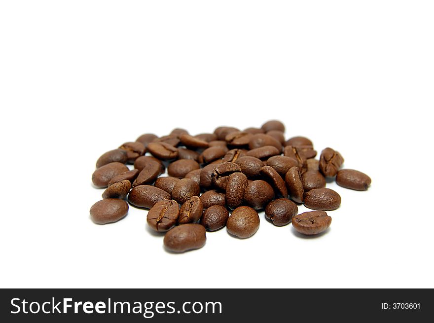 Heap of coffee beans isolated on white