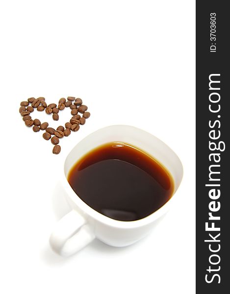 Cup of coffe and coffee beans in heart shape on white. Cup of coffe and coffee beans in heart shape on white