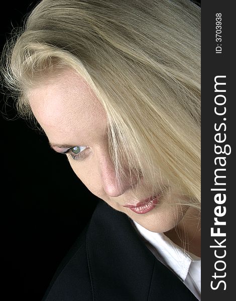Portrait of a blond woman, black background