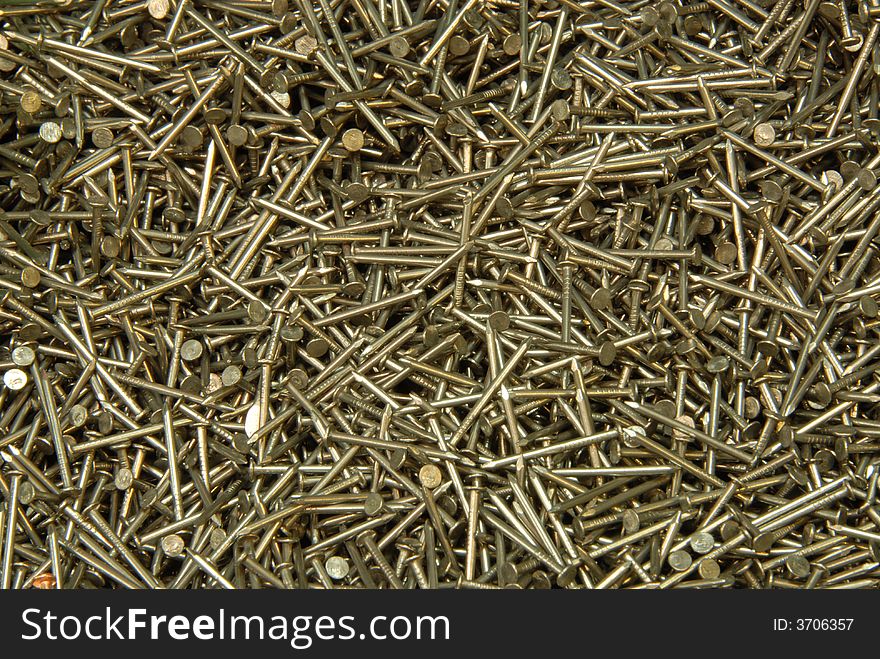 The heap of nails lays on a surface