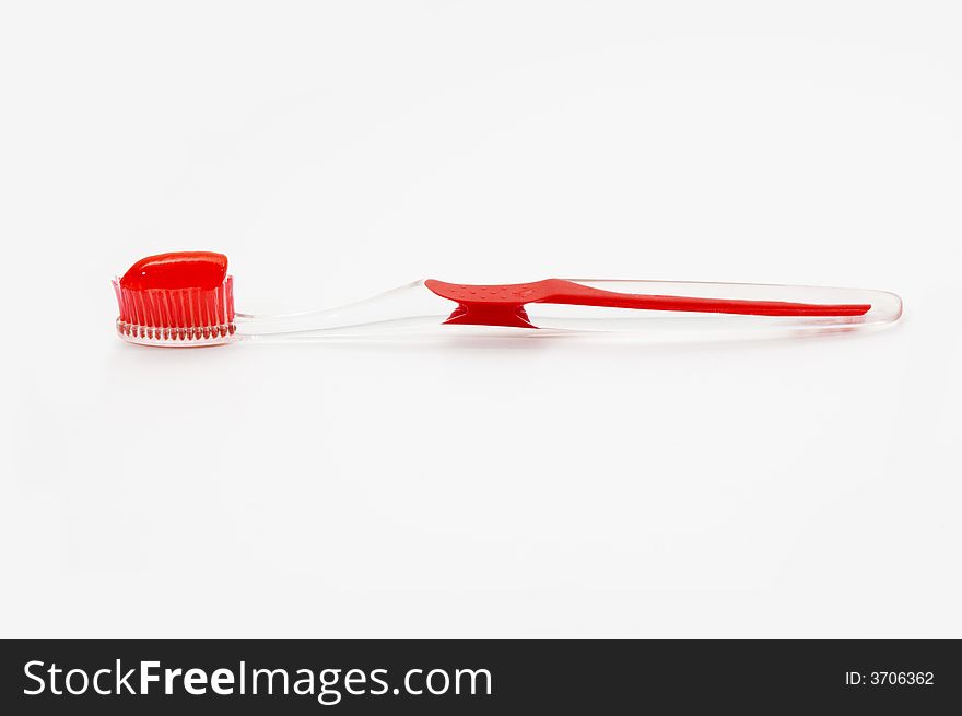 Red toothbrush with toothpaste isolated. Red toothbrush with toothpaste isolated